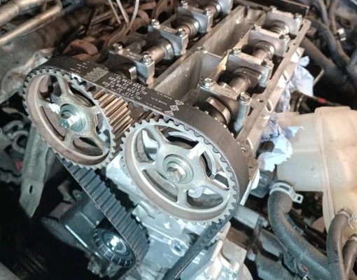Brand new timing belt and tensioner pulleys installed perfectly on an engine block in the garage